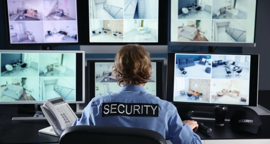 Security technician checking video camera footage